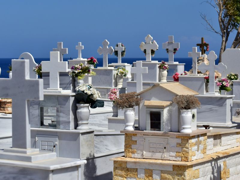 White marble graves with flowers in a seaside cemetery